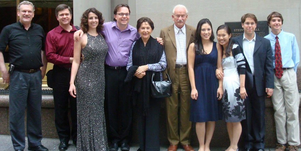 Ernst Mahle, Cidinha Mahle, and musicians posing in front of Steinway Hall, New York, NY